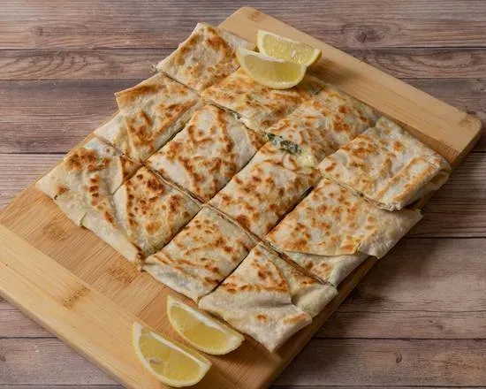 Gozleme cut into squares with lemon