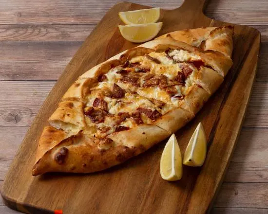 Turkish pide on a board with lemon