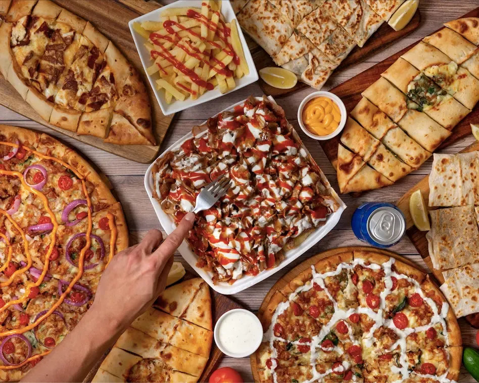 Pizzas, pide, gozleme and a snack pack spread across the table